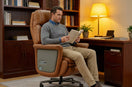 Man sitting in a ROCTRY Ellis brown office chair reading a book in a home office setting.