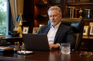 A CEO working at a desk while seated in a premium genuine leather executive office chair.