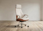 A modern high-back office chair with cream leather upholstery and brown wood-look side panels, mounted on a chrome five-star wheeled base, set against a minimalist beige wall and light wood floor.