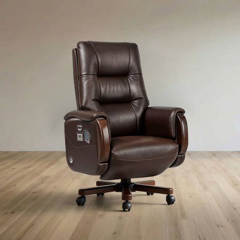 A dark brown leather office chair with a high back, padded armrests, and a five-star wheeled base, shown in a minimalist room with light wood flooring and a beige wall.
