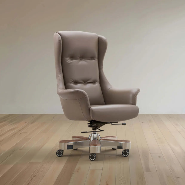Brown office chair on wheels in a room with wooden flooring and a beige wall.