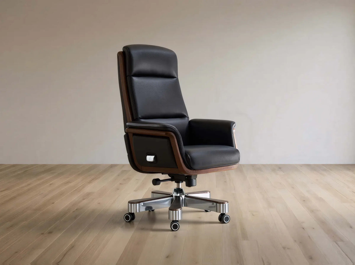 Black leather office chair on a wooden floor with a plain wall background