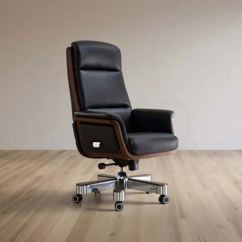 Black leather office chair on a wooden floor with a plain wall background