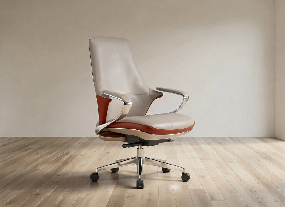 A modern office chair with a cream-colored leather seat and backrest, accented by reddish-brown leather panels on the sides, chrome armrests, and a five-star black wheeled base, set against a minimalist beige wall and light wood floor.
