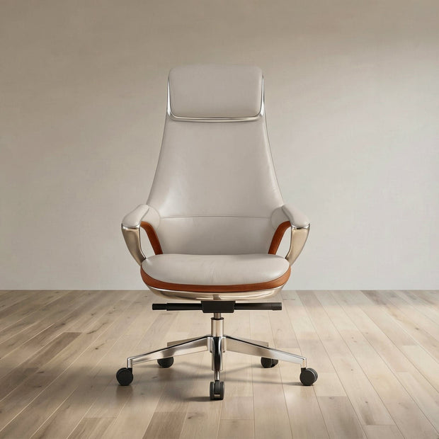 A modern high-back office chair with cream leather upholstery, brown leather arm accents, and a chrome five-star base, set against a minimalist beige wall and light wood floor.