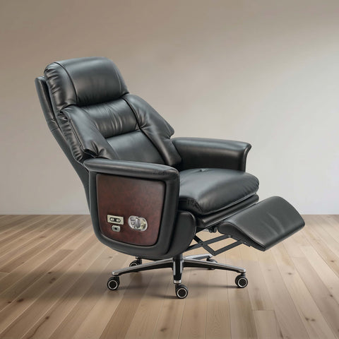 Black leather recliner office chair with extended footrest and wood-grain side panel, shown on a light wood floor against a neutral beige wall.