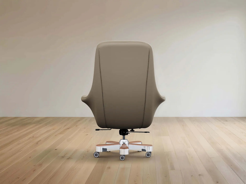 A modern high-back office chair upholstered in taupe leather, shown from the rear on a light wood floor against a neutral beige wall.
