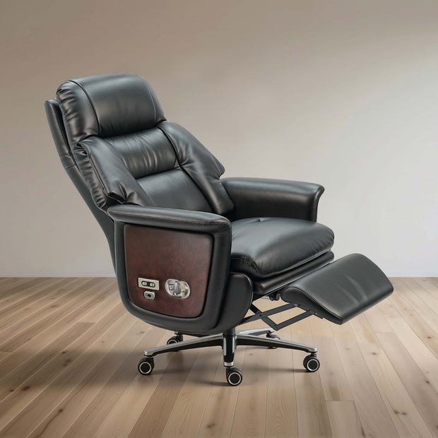 Black leather recliner office chair with extended footrest and wood-grain side panel, shown on a light wood floor against a neutral beige wall.