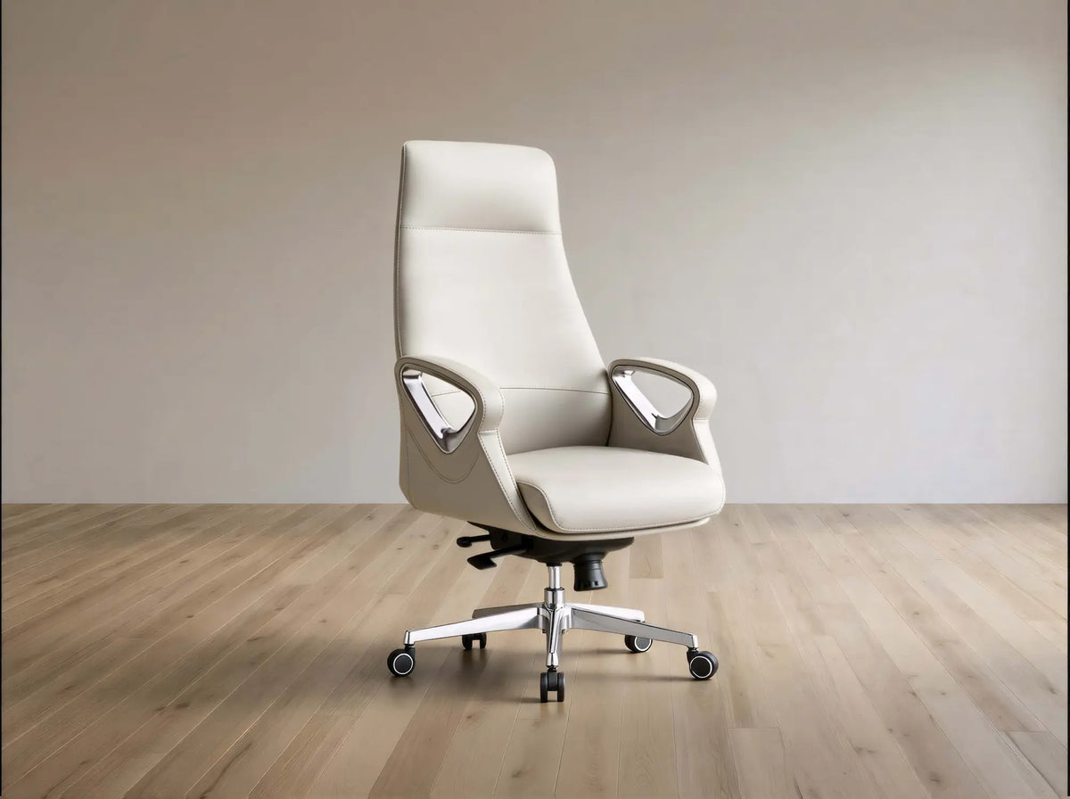 A modern high-back office chair upholstered in light beige leather, featuring chrome armrests and a five-star wheeled base, set against a minimalist beige wall and light wood floor.