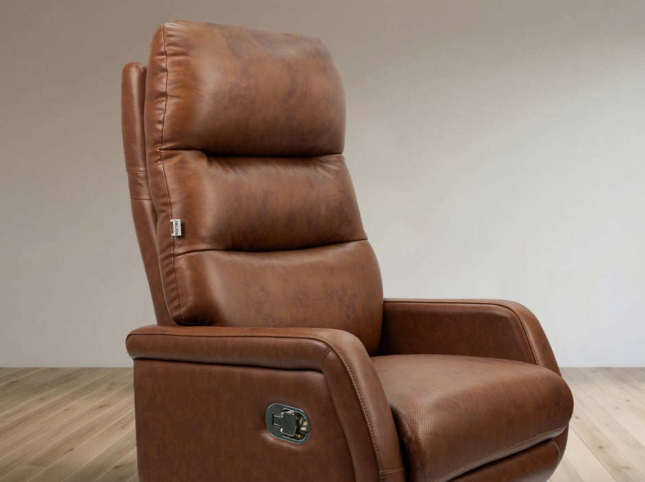 Brown leather recliner chair on a wooden floor with a neutral wall background
