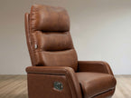 Brown leather recliner chair on a wooden floor with a neutral wall background