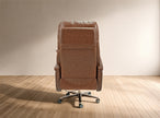 Brown leather recliner chair on a wooden floor with a beige wall background