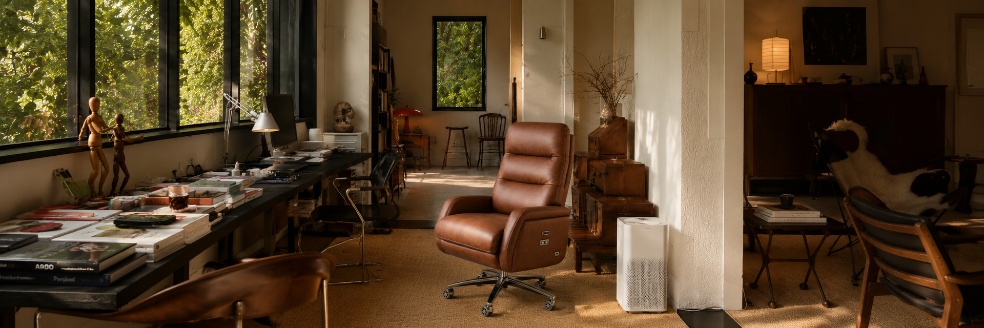 Modern office with a brown leather chair, desk, and large windows.